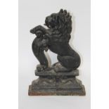 A cast iron door stop in the form of a lion