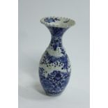 A large Chinese blue and white vase, with relief decoration of two dragons and crimped rim 41cm