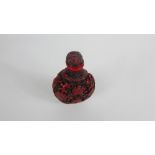 A red Chinese snuff bottle