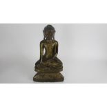 A Burmese wooden and gilt model of a seated buddha, possibly 18th century, 28cm high