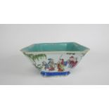 A Chinese shaped square bowl, decorated with various figures throughout with a turquoise interior