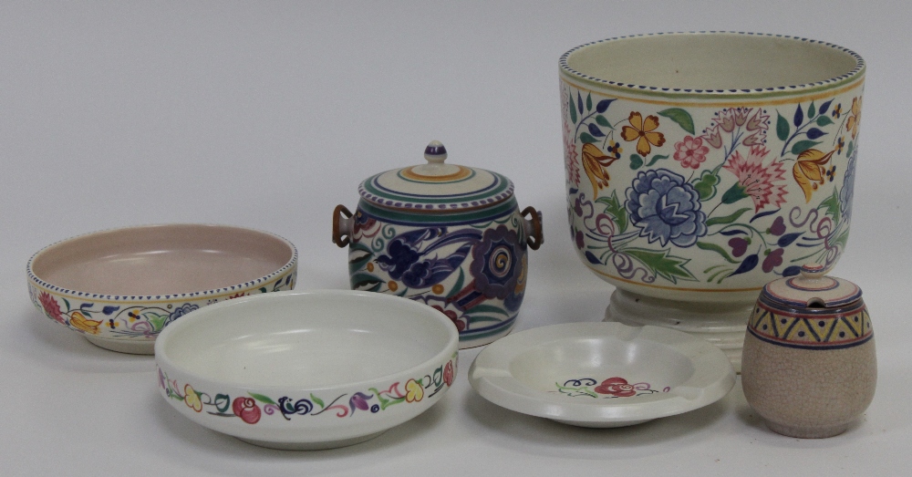 A collection of Poole items to include a jardiniere, along with a biscuit barrel, preserve pot,