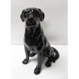 A fireside figure of a seated black Labrador, faint marks to base, 33cm high