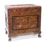 A modern carved camphorwood chest of small size, on four paw supports, 50cm high, 50cm wide