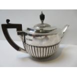 A George V silver teapot of oval form and with semi reeded body & wood handle, London 1912, 15.8ozt