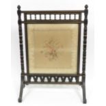 A Victorian fire screen having ebonised & gilt lined turned wood frame & central glass enclosing