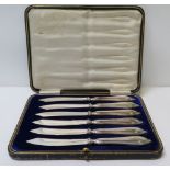 A cased set of silver handled fruit knives together with loose silver & other spoons, fobs & a