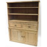 A Victorian stripped pine kitchen dresser the upper section with shelves & two short drawers the