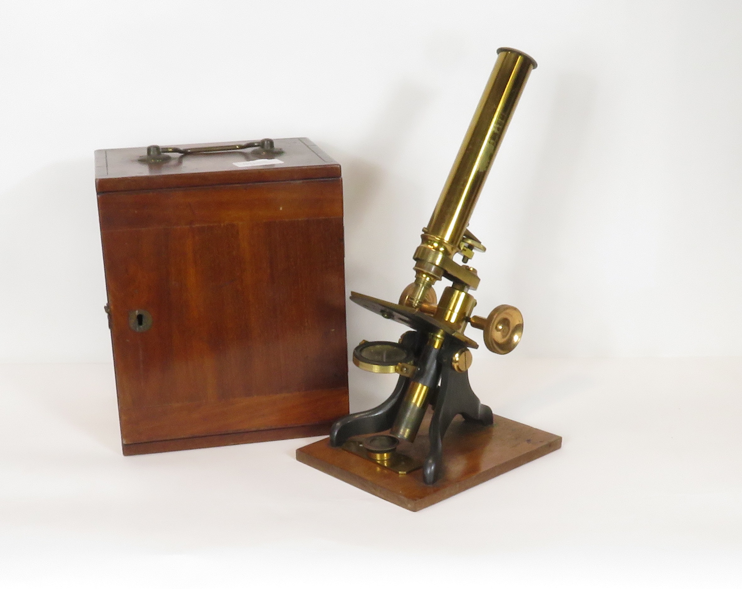 A late 19th/early 20th Century brass monocular microscope (unnamed) having single objective, with
