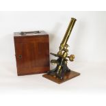 A late 19th/early 20th Century brass monocular microscope (unnamed) having single objective, with