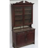 An early 20th Century oak bookcase the back with pair of glazed doors enclosing adjustable shelves &