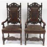 A pair of imposing 19th Century Jacobean style oak open armchairs, the upholstered tall back with