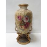 A large Victorian pottery vase of baluster form on openwork supports and circular base, painted with