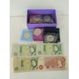 A quantity of modern commemorative coins, some in wallets etc and two £1 notes & a 10/- note