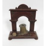 A small Victorian table bell in carved oak support & with striker, 39cm high, 33.5cm wide