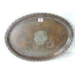 An Arts and Crafts oval tray by Hugh Wallace, with white metal banding to edge & carved with