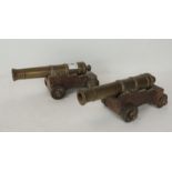 A pair of bronze desk cannons having turned barrels on wood bases, 21cm long