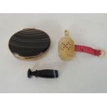 A Victorian ivory cased sewing tape measure, the finial set with a stanhope containing images of