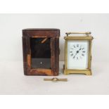 A late 19th Century French eight day carriage timepiece in plain brass case, having white enamel