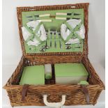 A Brexton woven cane picnic hamper complete with contents including ceramic plates, cups &