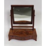 A 19th Century mahogany dressing mirror having serpentine base fitted with three small drawers, 45cm