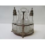 A George III silver cruet stand of Neo classical design and containing six contemporary cut glass