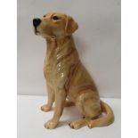 A Beswick fireside figure of a seated yellow Labrador, 34cm high