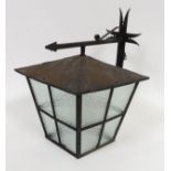 An external light fitting, black painted metal casing and textured glass panels, 53cm high max.