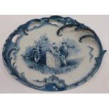 A 19th Century Delft charger with raised & open foliate edging and painted with a couple dancing,