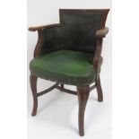 An early 20th Century oak office chair of tub type, upholstered in green rexine