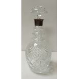 A heavy clear glass decanter and stopper having silver collar, 30.5cm high