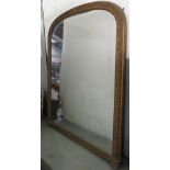 A Victorian arched gilt gesso overmantel mirror on original white ceramic ball supports, 165cm x