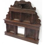A Victorian carved oak overmantel with central small mirror the whole with floral & foliate carved &