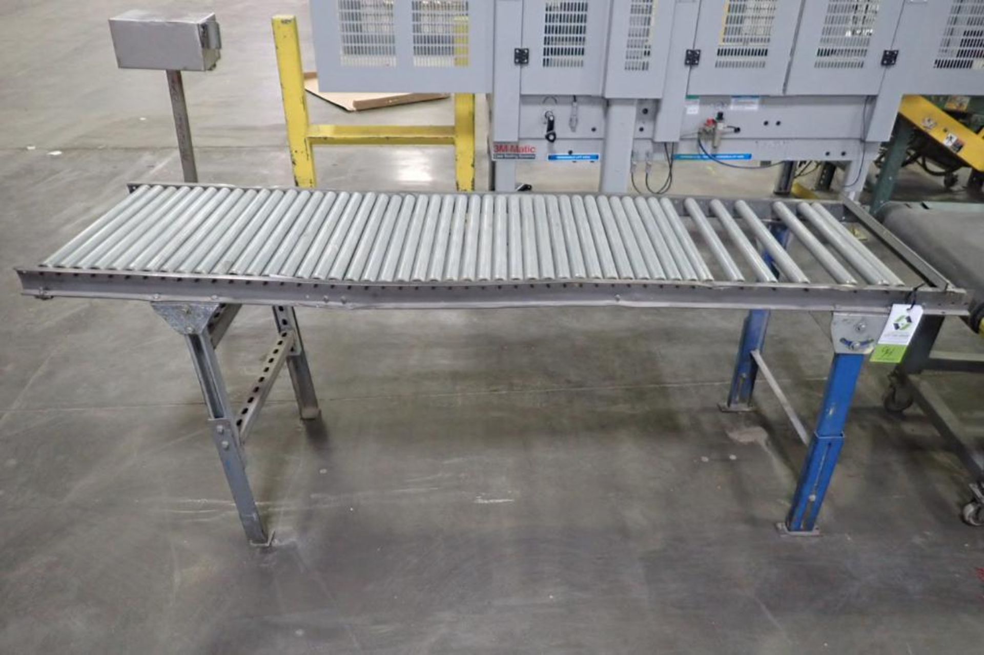 Gravity roller conveyor, 84 in. long x 22 in. wide x 35 in. tall, adjustable legs, damaged frame. **