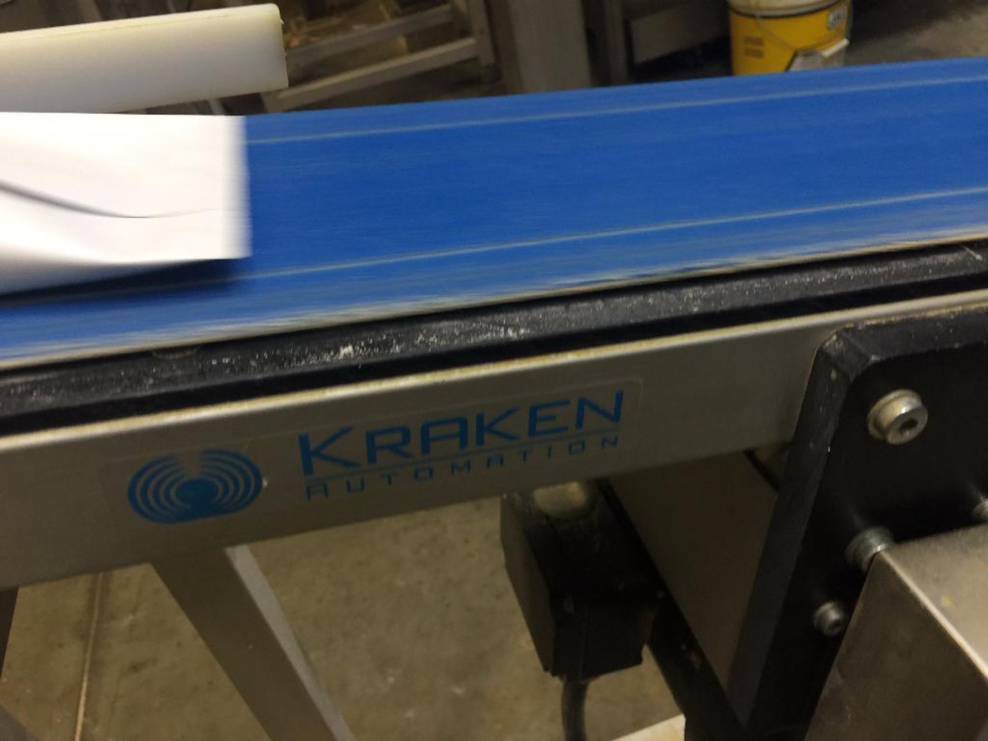 Kraken conveyor, 79 in. x 6 in. incline out of filler, blue belt, motor and drive. **Rigging Fee: $2 - Image 3 of 4