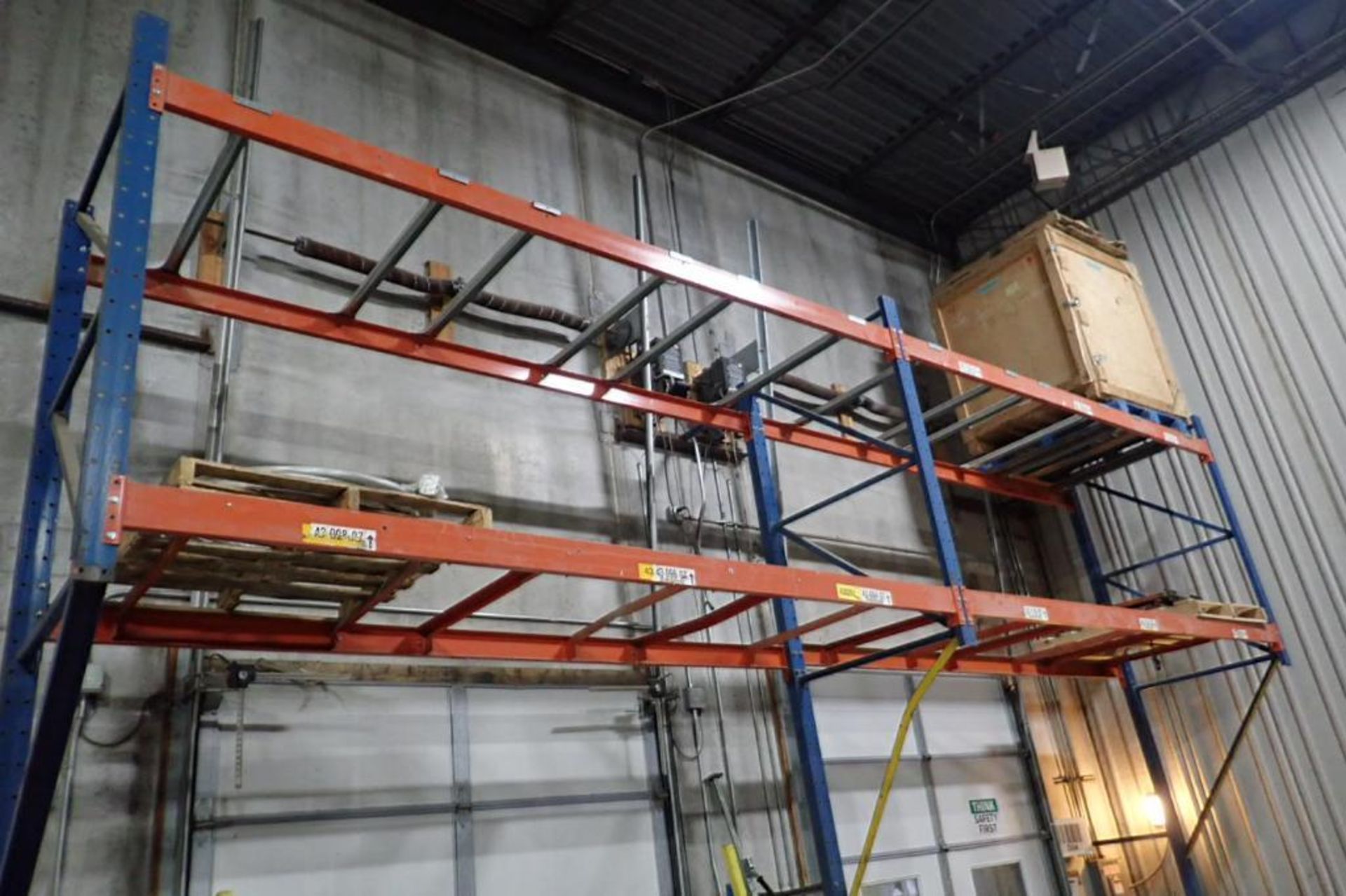 (2) bays wall mount pallet rack above shipping doors, 12 ft. wide, 16 ft. tall.. **Rigging Fee: $250 - Image 2 of 4