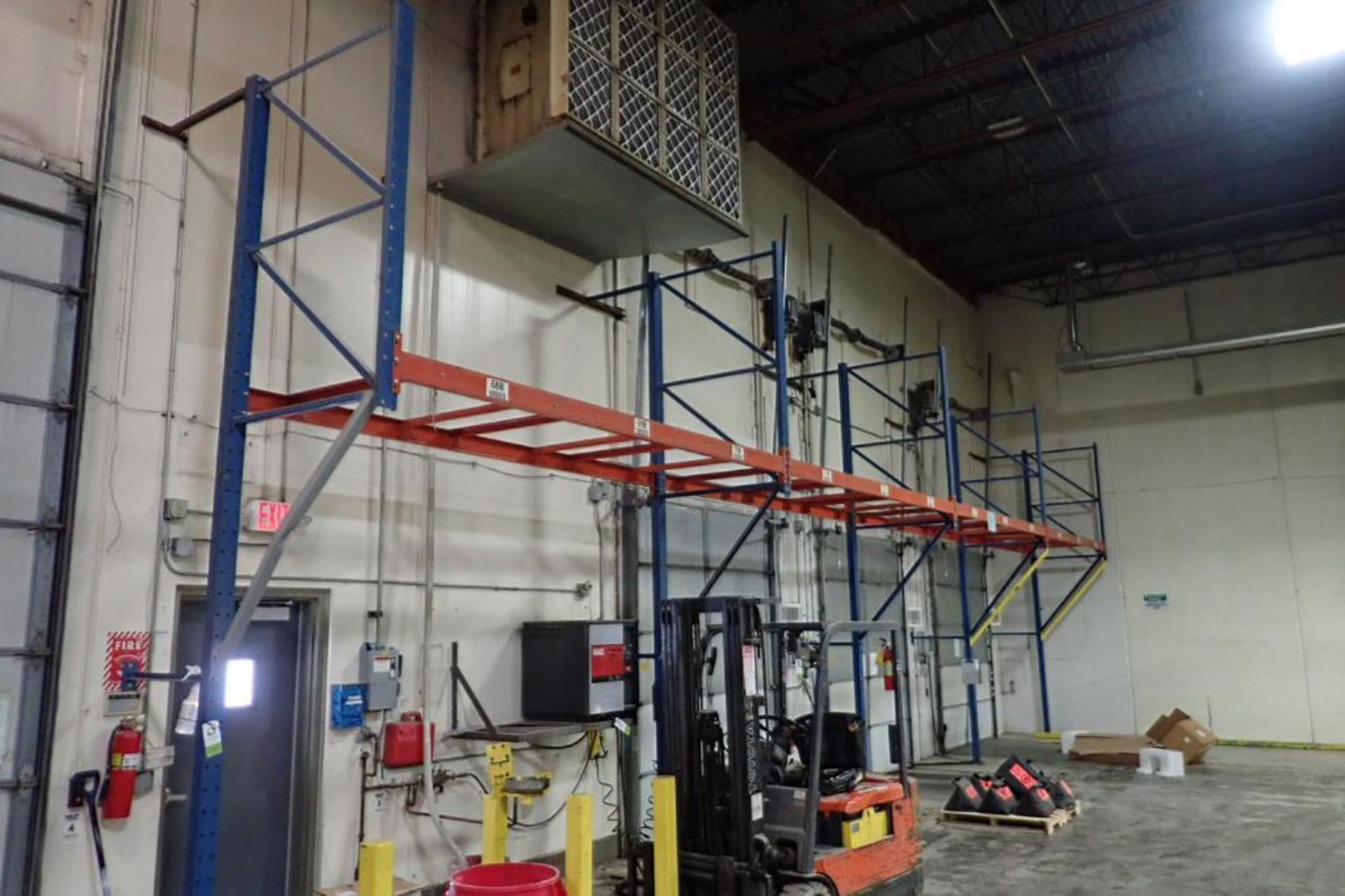 (6) bays wall mount pallet rack above shipping doors, 12 ft. wide, 16 ft. tall.. **Rigging Fee: $300