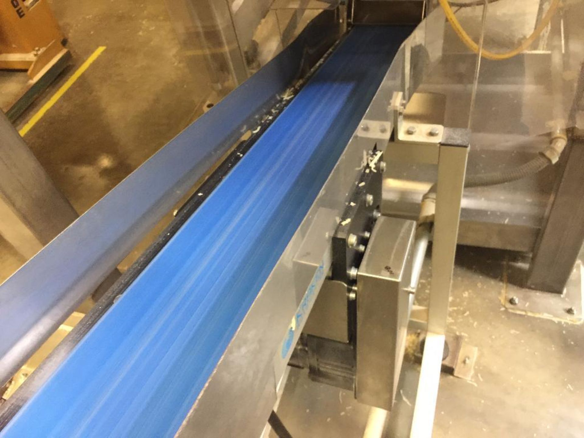 Kraken conveyor, 79 in. x 6 in. incline out of filler, blue belt, motor and drive. **Rigging Fee: $2 - Image 4 of 4