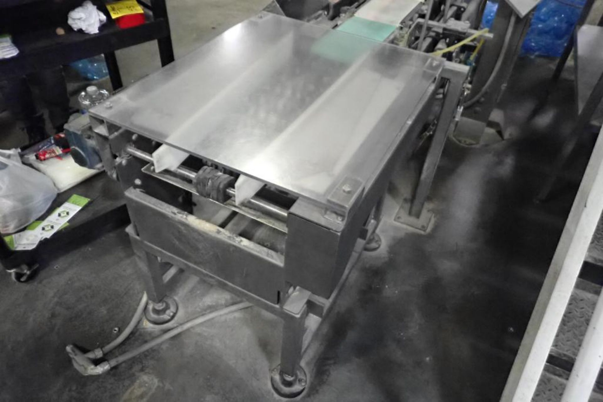 Laning conveyor, 12 in. wide to 8 in. wide., motor and drive.. **Rigging Fee: $150** (Located in Bro