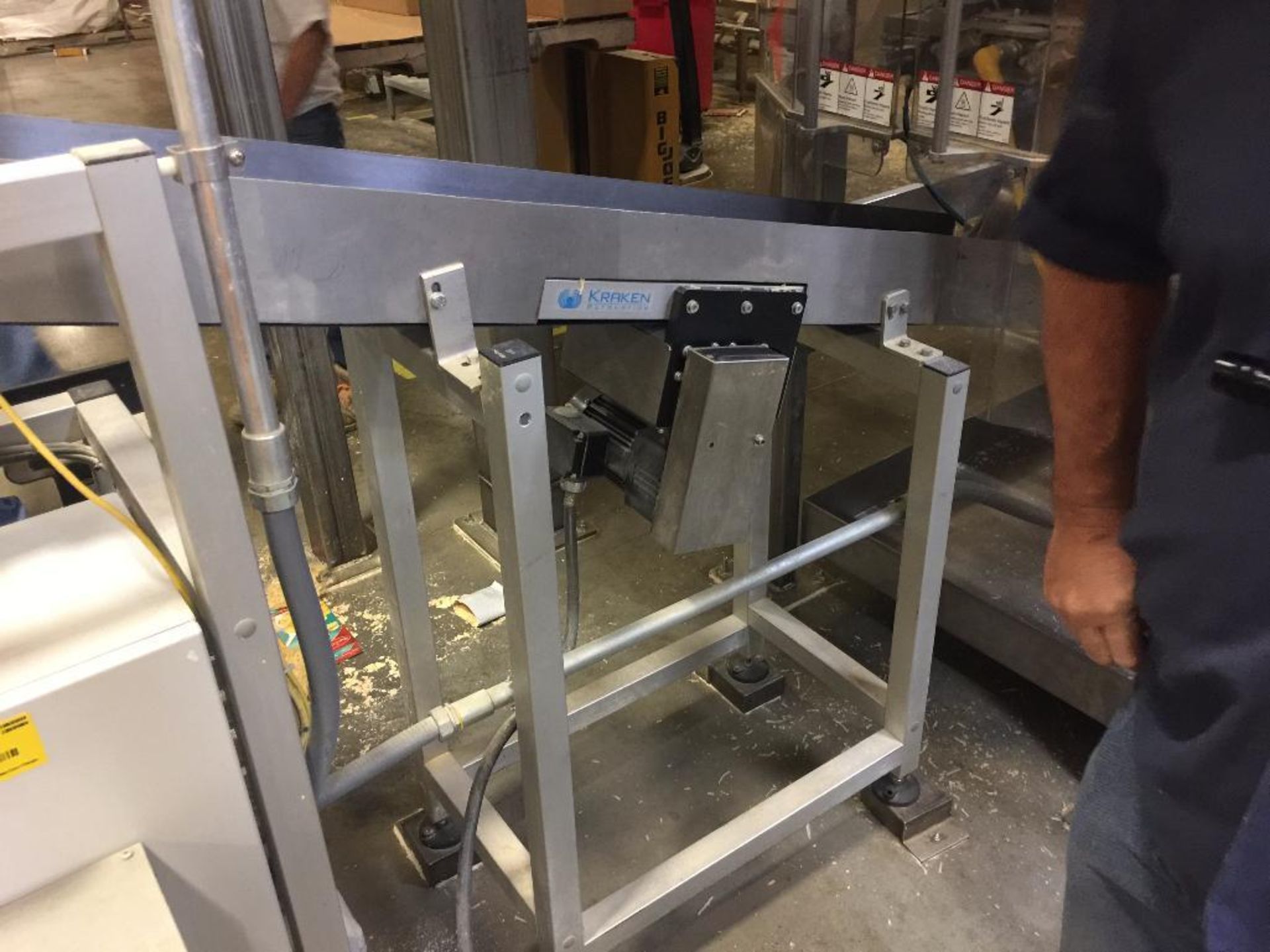 Kraken conveyor, 79 in. x 6 in. incline out of filler, blue belt, motor and drive. **Rigging Fee: $2