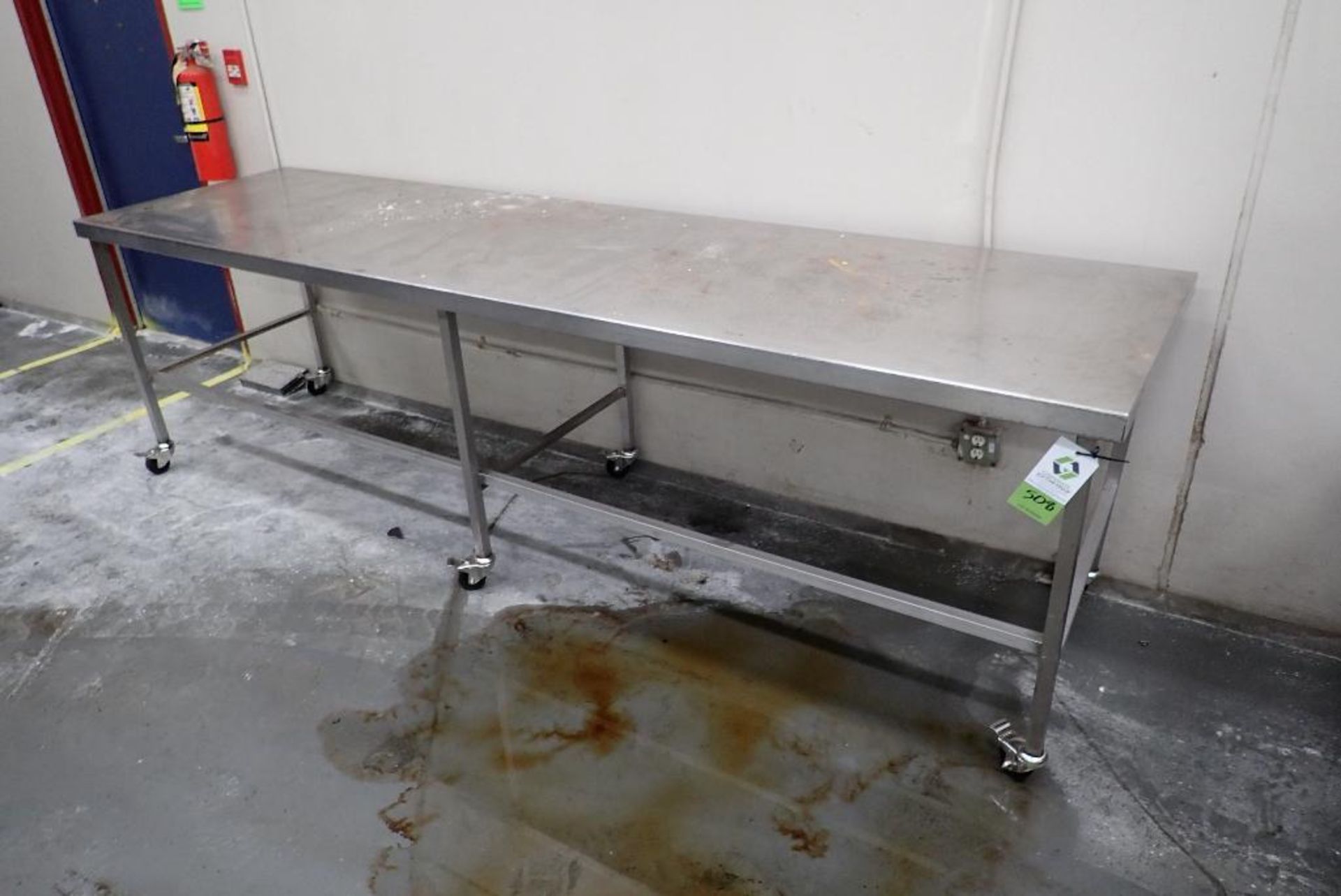 SS table, 120 in. long x 32 in. wide x 35 in. tall, on casters. **Rigging Fee: $75** (Located in Del