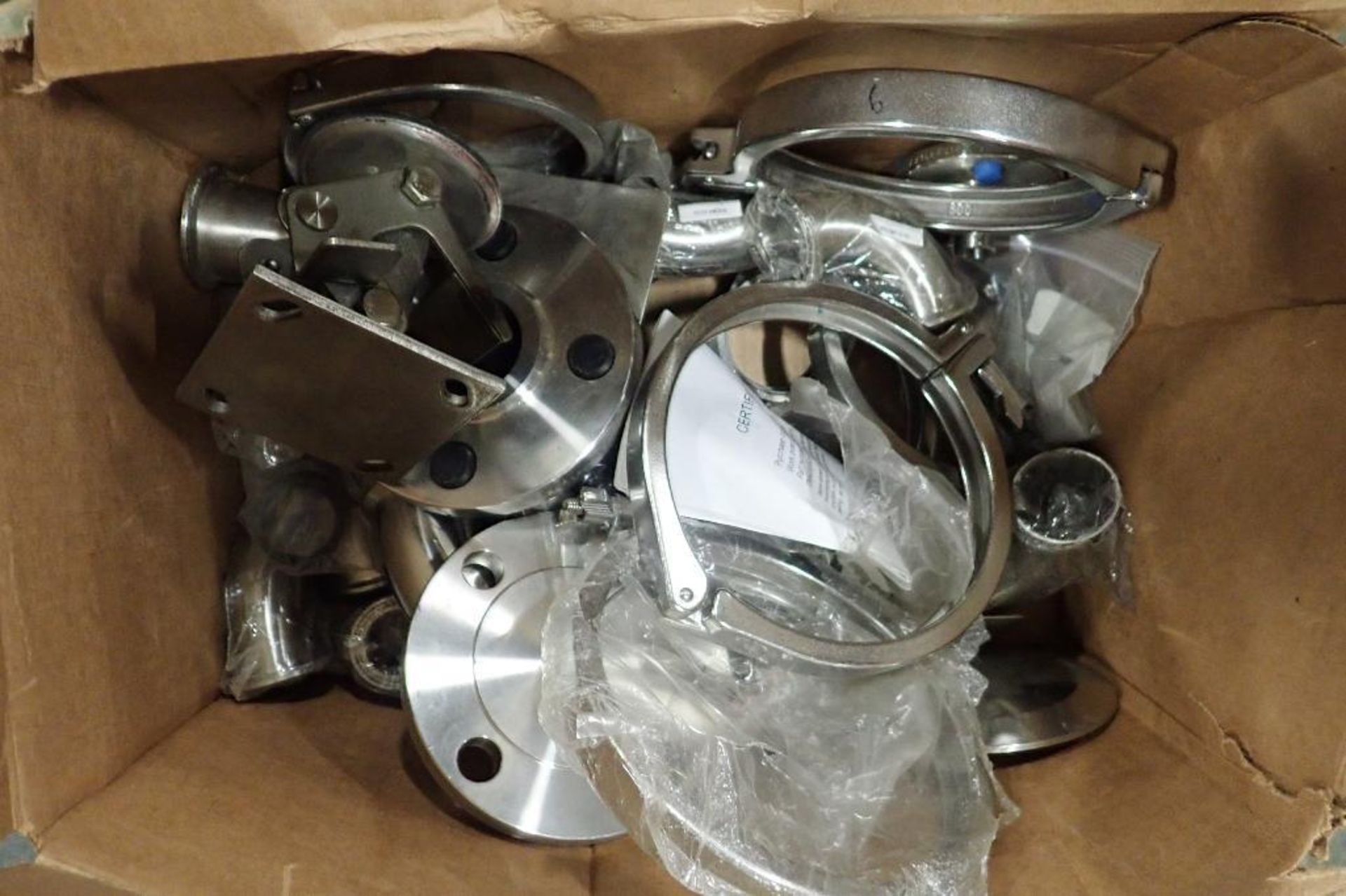 Lot of SS elbows, plates, sanitary connectors,. (See photos for additional specs). **Rigging Fee: $2