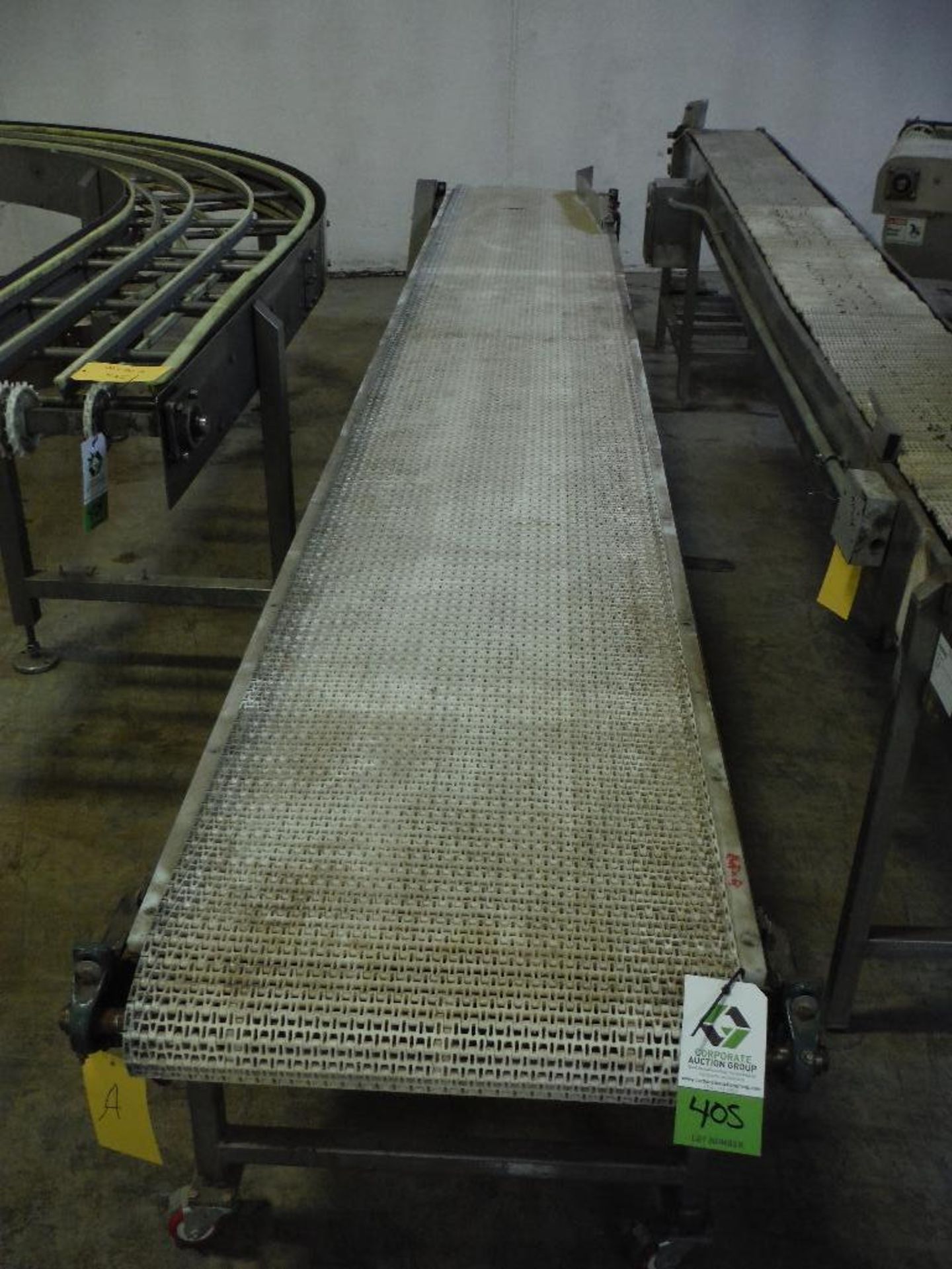 Belt conveyor, 190 in. long x 24 in. wide x 27 in. tall, motor and drive, carbon steel frame, on cas