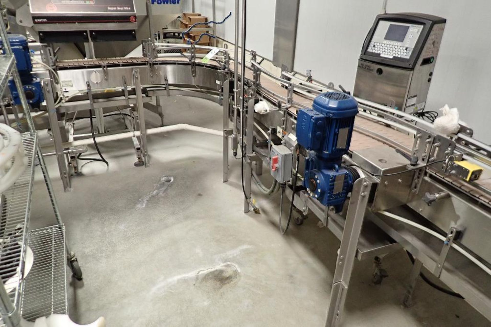 SS bottle conveyor, 90 degree turn from bottle filler to labeler, 18 ft. long x 7.5 in. wide x 40 in