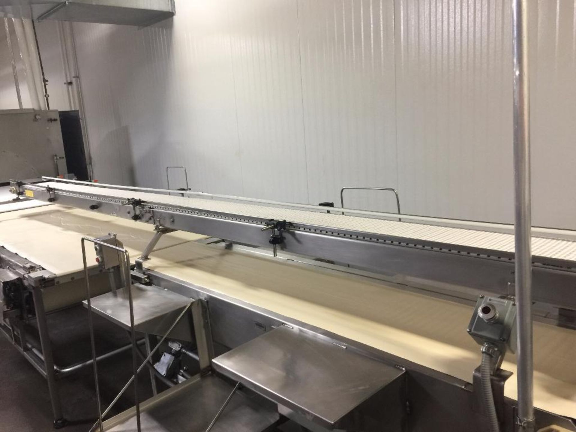 SS conveyor, 196 in. x 10 in., white plastic belt, motor and drive, mounted on top for finished prod