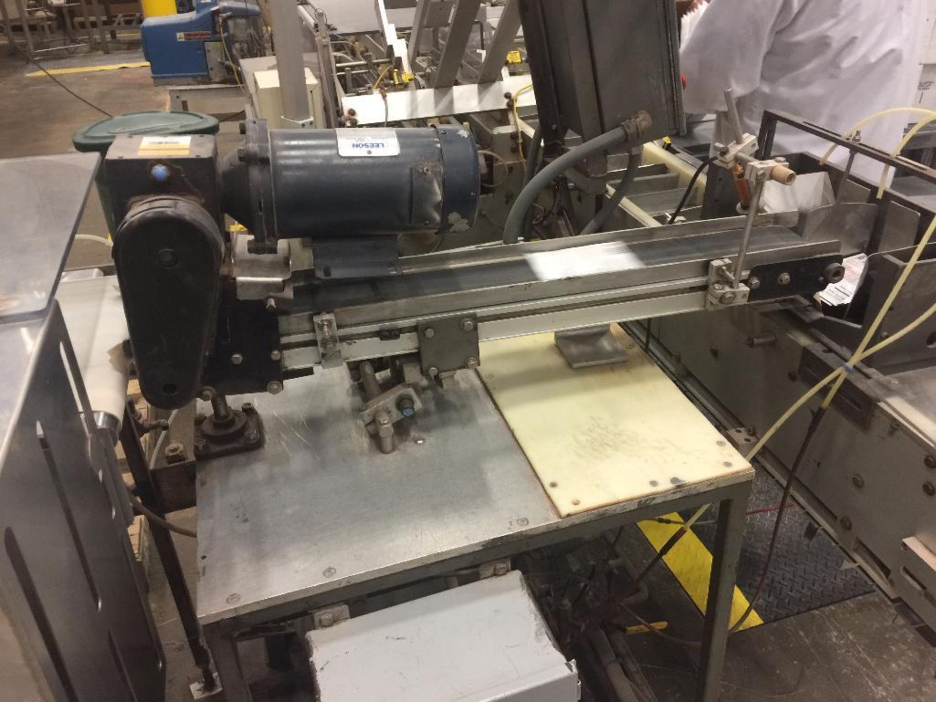 Timing conveyor from x-ray to carton inserter, 24 in. x 3 in., mounted on table. - ** Located in Med