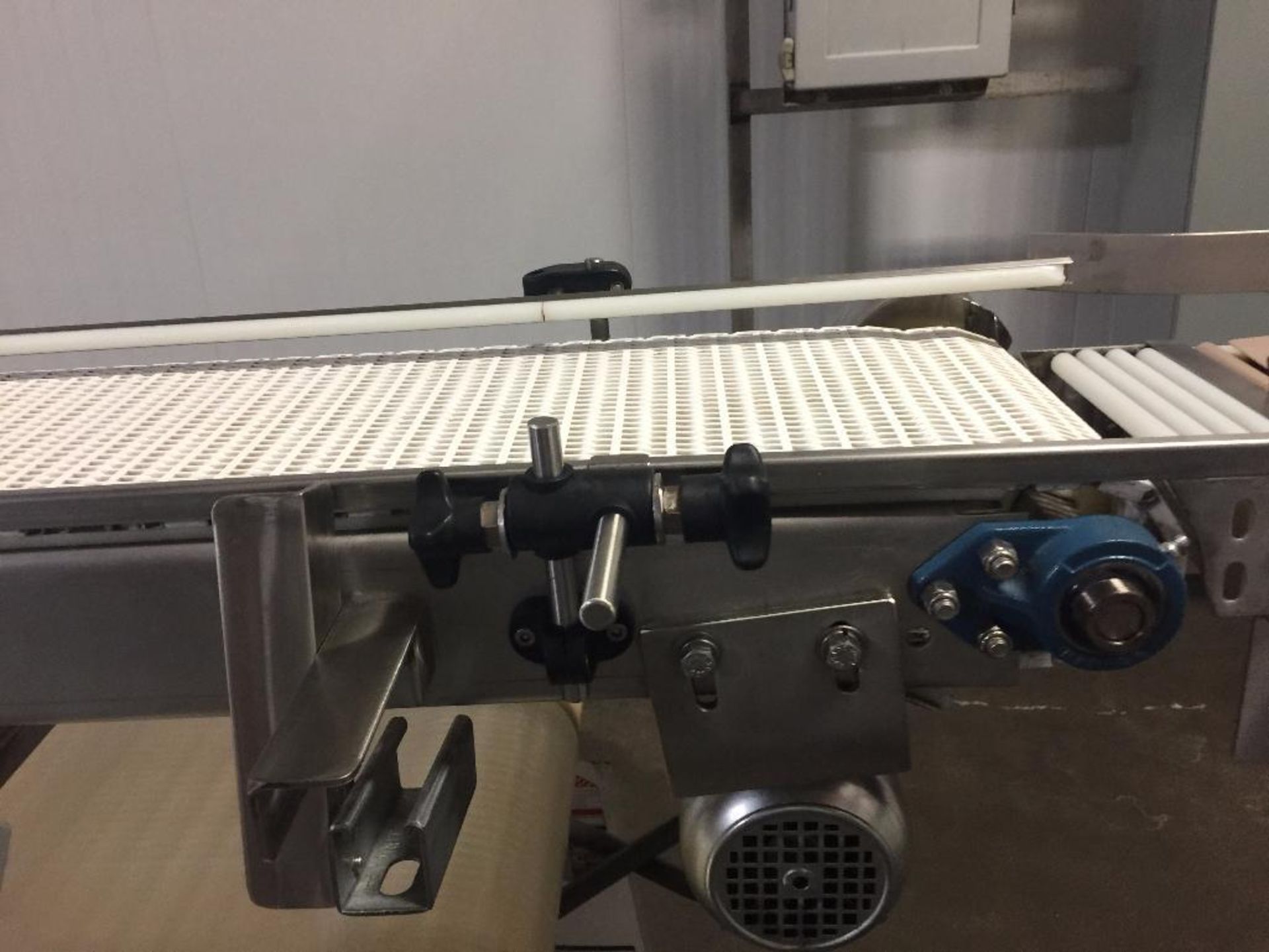 SS conveyor, 196 in. x 10 in., white plastic belt, motor and drive, mounted on top for finished prod - Image 2 of 6