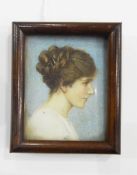 Early 20th century portrait miniature on ivory of a young girl in profile with her dark hair up,