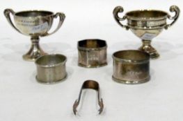 Two 1930's silver small tennis trophies and three silver napkin rings (5)