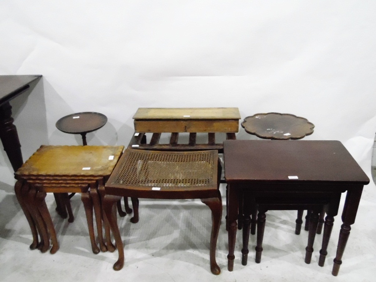 Nest of four walnut tables with carved decoration,